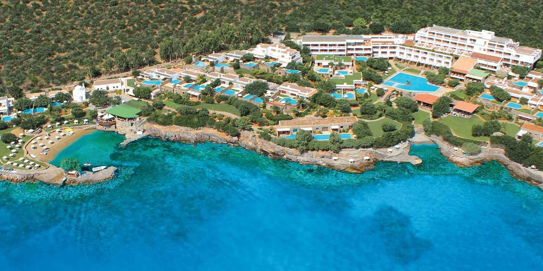 Elounda hotel exterior view in full next to the beautiful blue beach