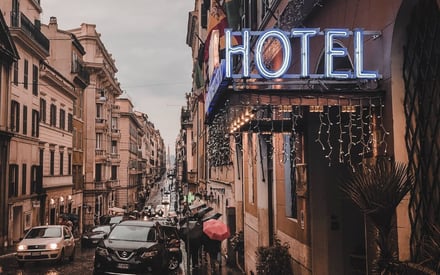 Hotel facade with sign on busy street