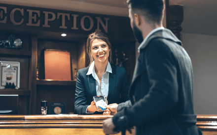 Keys hand off at a hotel reception desk