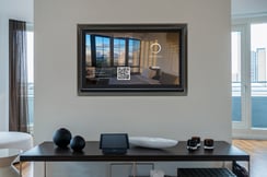 A hotel room with a big hotel tv.