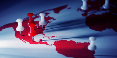 a red map of the Americas with pins on North America to symbolize US expansion