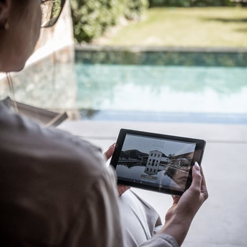 Woman holding The Olivar Suites SuitePad