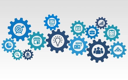 Blue cogs intertwined with icons depicting different jobs at a hotel