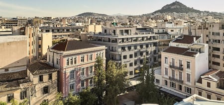 Perianth hotel exterior with hill in the background