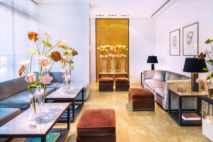 Elegant lounge area at The Mandala Hotel featuring modern seating, floral arrangements, and contemporary interior design