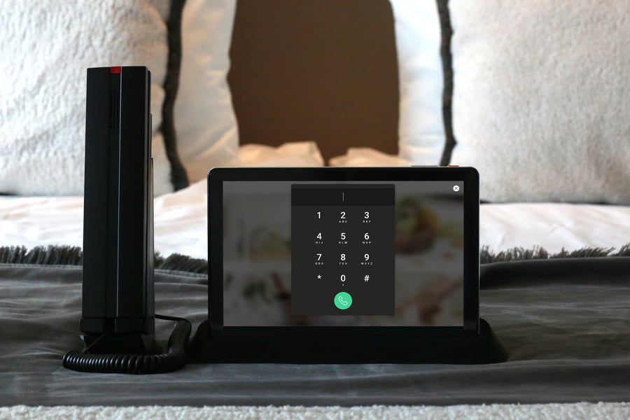 Front view of the SuitePad Phone Dock showing the SuitePad in-room tablet and corded handset held together in one base