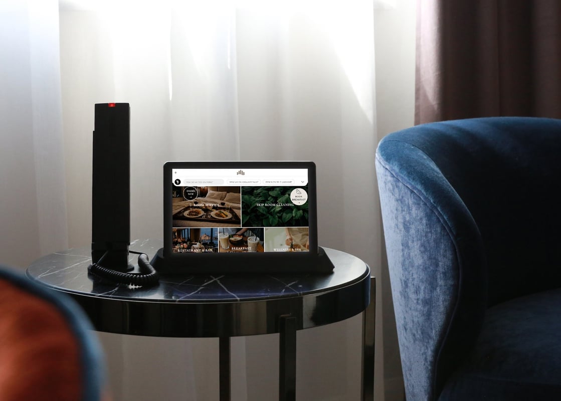 SuitePad Phone Dock on a side table next to an armchair