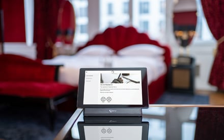 SuitePad hotel room tablet on a coffee table in a hotel room