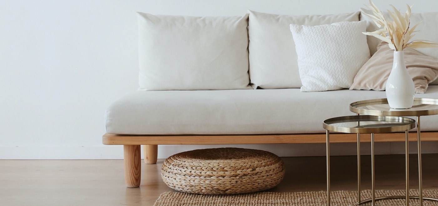 A sofa and a table with decoration in front of a wall