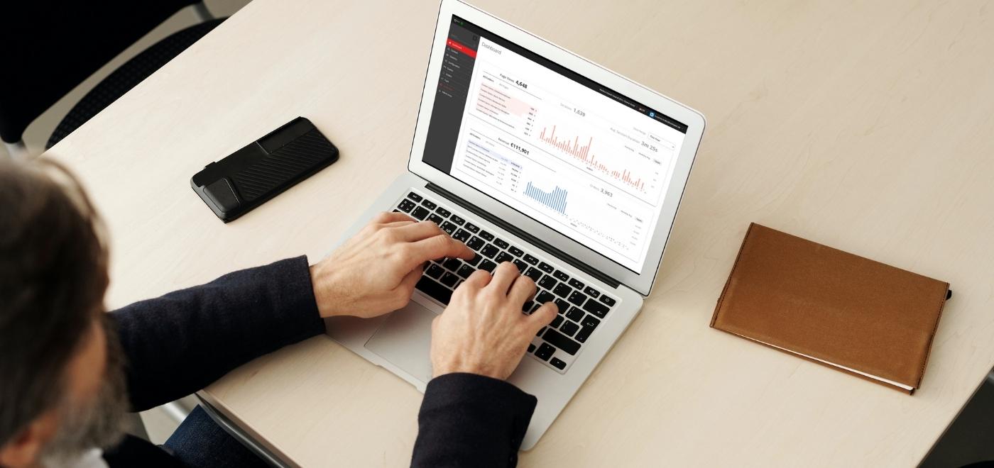 Man in front of laptop with SuitePad Dashboard