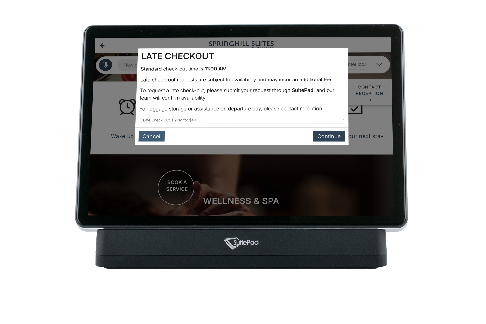 A guest choosing a late check-out time on the SuitePad in-room tablet at SpringHill Suites Oceanside Beach