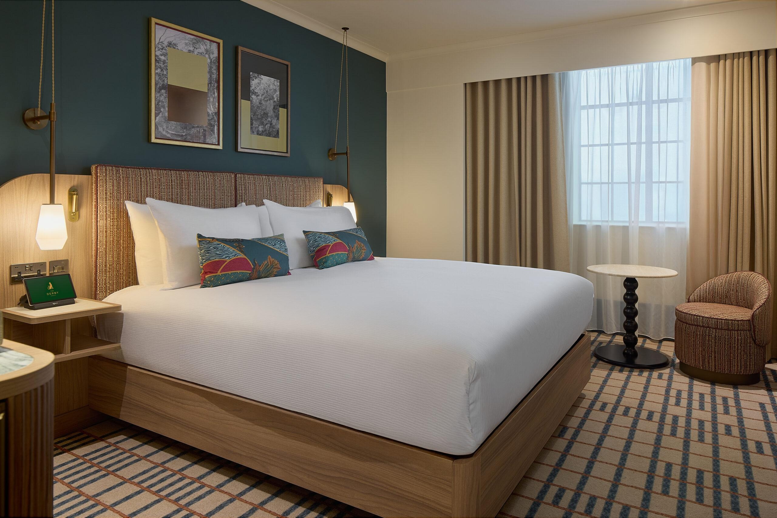 The Derby London City Curio Collection by Hilton King Deluxe Room with the SuitePad in-room tablet on the nightstand