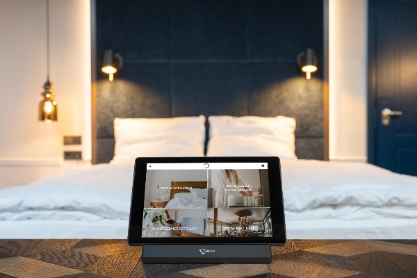 SuitePad tablet on nightstand in hotel room