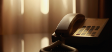 old hotel phone on a table with a sepia filter