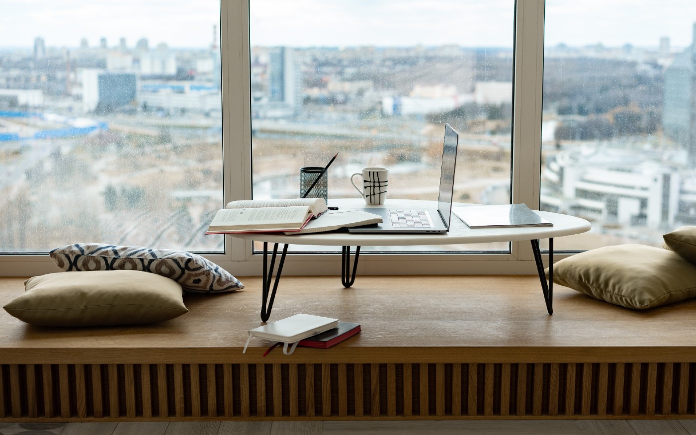 Laptop in hotel room in front of window